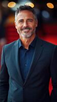 Actor poses confidently in tailored suit on red carpet during gala event at night photo