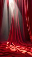 Red curtains draped in soft light create a dramatic atmosphere for a performance venue or theatrical backdrop photo