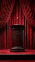 Elegant podium stands ready for a speech in a theater adorned with rich red curtains, illuminated by soft lighting photo