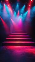 Colorful lights illuminate a staircase in a performance venue during a nighttime event photo