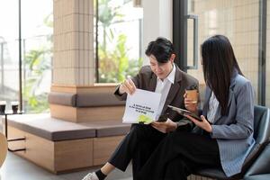 Business team reviewing project report and analyzing strategies in a modern office environment. photo