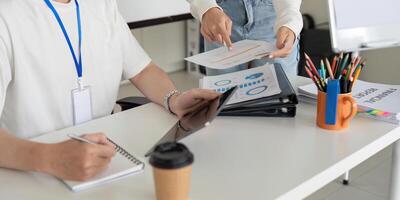 Team discussing financial reports and strategies in a modern office photo