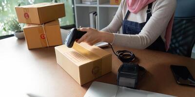 Using a barcode scanner on a package for shipping preparation photo