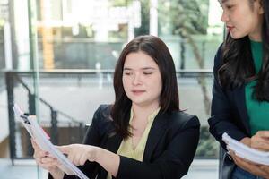 Team members collaborating on financial analysis and strategy in a modern office setting. photo