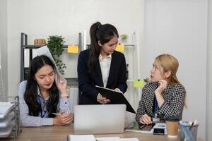 Professionals discussing financial strategies while facing challenges in a modern office environment. photo