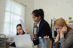 Team discussing financial strategies and challenges in a collaborative office setting. photo