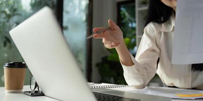 Accountant discussing financial strategies while holding a pen and reviewing documents. photo