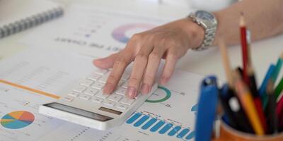 Close-up of a hand using a calculator for financial analysis and budgeting. photo