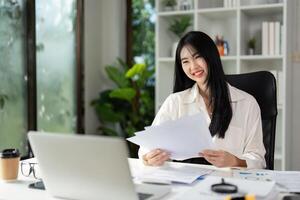 Smiling accountant reviewing tax documents and enjoying a productive workday. photo