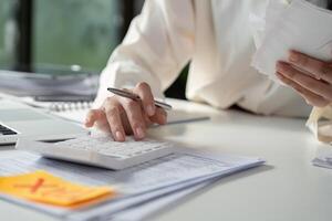 Detailed view of financial calculations with a calculator and tax documents spread on a desk. photo