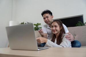 Couple collaborating on a laptop while enjoying family time photo