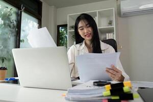 Focused accountant analyzing financial statements and preparing for tax filing at a desk. photo