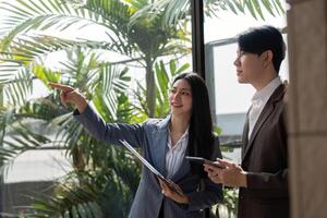 Team members discussing and analyzing ideas with sticky notes and charts in a modern office. photo
