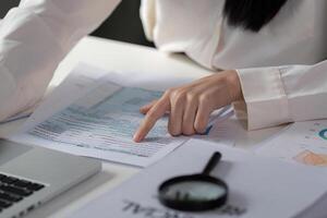 Professional preparing tax documents using a laptop and calculator for financial filing. photo