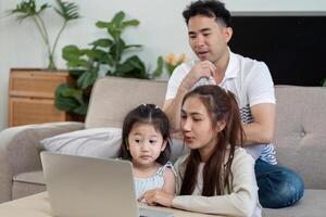 Mother and daughter sharing a joyful moment while looking at a laptop photo