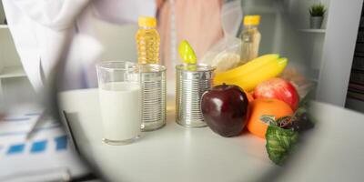 Nutritional evaluation. A nutritionist highlighting food items during a consultation. photo