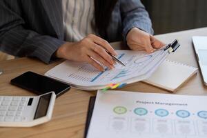 Detail-oriented analysis. Close-up view of a business professional analyzing project data and charts while planning future strategies. photo