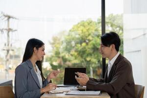 Collaboration in planning. Two professionals discussing project strategies in a modern workspace. photo