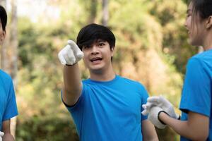 Volunteer pointing and directing efforts during a community clean-up, fostering teamwork and engagement. photo