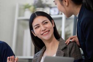 Teamwork and positivity. Colleagues share a light moment while discussing tax strategies and analysis in the office. photo