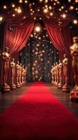 Golden statues stand on a red carpet in a lavish hall illuminated by bright lights during an award ceremony celebration photo
