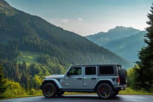 Jeep Wrangler Rubicon 4x4 parked on a mountain road overlooking a valley photo
