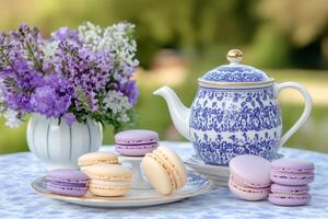 Delicious macarons and elegant teapot enjoying a spring afternoon photo