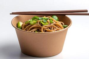 Noodles with cucumber and green onions in takeaway biodegradable bowl with chopsticks photo