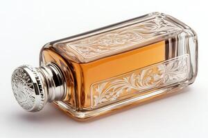 Elegant crystal perfume bottle with silver cap lying on white background photo