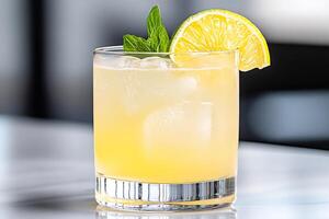 Refreshing whiskey sour cocktail garnished with lime and mint photo