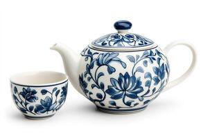 Blue and white porcelain teapot and teacup with floral design photo