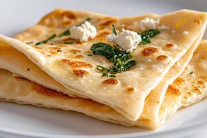 Delicious homemade flatbreads seasoned with herbs and feta cheese lying on white plate photo