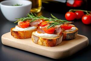 Delicious bruschetta with cream cheese, bacon and cherry tomatoes lying on wooden board photo