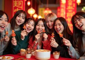 Four young women eating food at a table photo