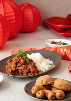 A table with plates of food and a plate of cookies photo