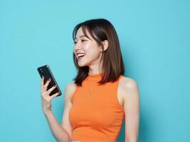 Asian woman holding phone and smiling photo