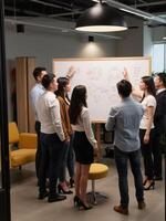 A group of people standing around a whiteboard photo