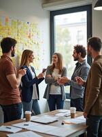 Group of people standing around a table in an office photo