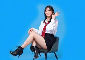 A woman in a school uniform sitting on a chair photo