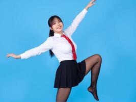 Asian woman in school uniform jumping in the air photo