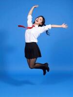 A woman in a school uniform is jumping photo