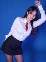 A woman in a school uniform posing for the camera photo