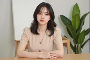 A woman sitting at a table with her arms crossed photo