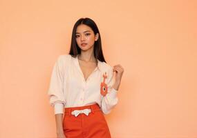 A woman in an orange skirt and blouse photo