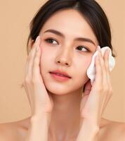 Beautiful asian woman with white towel on her face photo
