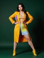 poised woman wears an oversize 2025 futuristic ensemble with geometric patterns and metallic finishes, set against a dark green background photo