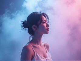 A woman in a white tank top is looking up at the sky photo