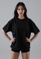 The model wears a black t - shirt and shorts photo