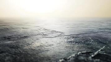 Close-up of a flat gray surface with a textured appearance set against a soft blurred background of diffused light A calm stone-like surface photo