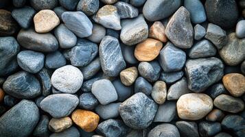 A pile of rocks with some of them being gray and some of them being brown photo